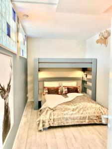 a bedroom with a large bed and a deer on the wall at Poppenberg Lodge in Winterberg