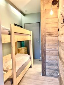 a bedroom with two bunk beds and a closet at Poppenberg Lodge in Winterberg