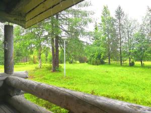 a view of a field from a wooden fence at Lumomaa Ruka in Ruka +4 photos