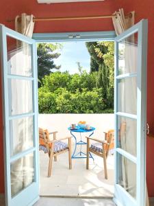 an open door to a patio with a table and chairs at Giannakis Filoxenia in Filótion