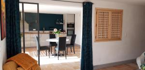 a dining room and kitchen with a table and chairs at LA VIGNERAIE in Albiac