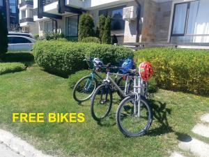 two bikes parked in the grass in front of a house at F307 Studio Aspen Golf Resort Bansko in Bansko