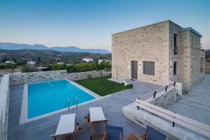 a villa with a swimming pool on a roof at Villa Eleana in Pitsidia
