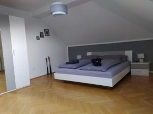 a bedroom with a bed and a wooden floor at City FeWo in Schwelm