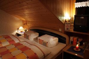 a bedroom with a bed in a wooden room at Ferienhof Metzler in Schwarzenberg im Bregenzerwald