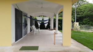 a screened in porch with a hammock on it at Peaceful and beautiful Casa Almita Bonita in Sámara