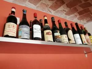 a bunch of wine bottles sitting on a shelf at Casa Carolina in Castellinaldo