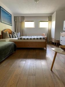 a bedroom with a bed and a couch in it at FeWo Martha in Zinnowitz