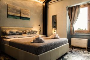a bedroom with a bed with towels on it at Giulia camere in Numana
