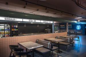 a restaurant with tables and chairs and a sign that says should stay ok at Stay Hotel in Brunello