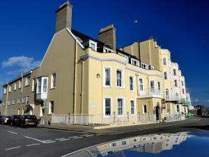 a large yellow building on the side of a street at Atlantic Hotel in Tenby