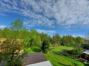 a view from the roof of a house with a field and trees at Apartman Tinče in Delnice