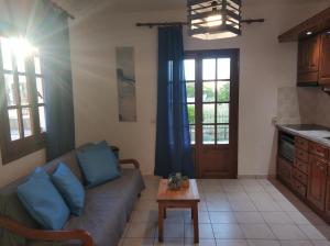 a living room with a couch and a table at Litus Amoris 2 in Sidari