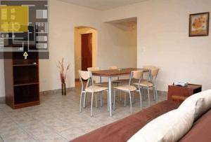 a dining room with a table and chairs at Wilson Apart Hotel in Salta