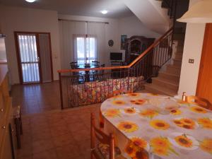a dining room with a table with flowers on it at Casa Adriana in Alghero
