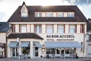 a building with a sign on the front of it at Au Bon Accueil in Juvigny-sous-Andaine