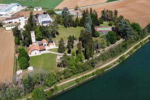 an aerial view of a house next to a body of water at Domaine des Cèdres -- hôtel, résidence, gîtes et insolites in Villebois