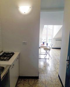 a kitchen with a stove and a table in a room at Casa di Clara in Rapallo