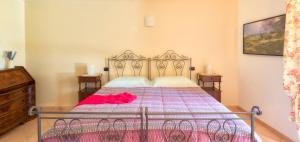 a bedroom with a bed with a red blanket on it at Bed&Breakfast Il Frantoio in Misano Adriatico
