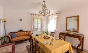 a dining room with a table and a couch at Bed&Breakfast Il Frantoio in Misano Adriatico +7 photos