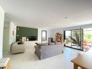 a living room with a couch and a table at Menta House preciosa eco-casa con gran jardin y barbacoa in Alcover
