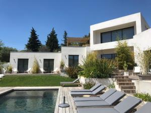 a villa with a swimming pool and a house at Villa le sud appartements in Cassis