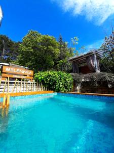 a swimming pool with a bench next to a building at Milennia Family Hotel in Sunny Beach +35 photos