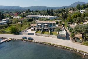 an aerial view of a house next to a river at Swans Luxury Homes in Kommeno