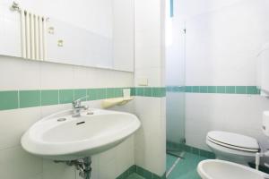 a bathroom with a sink and a toilet at Bellariva Feeling Hotel in Rimini