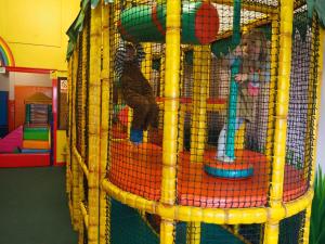 a cage with two children playing in it at Watermouth Lodges in Ilfracombe