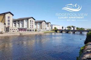 a view of a river with buildings and a bridge at Ballina Apt, Views of Ridgepool, Central Location in Ballina