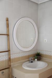 a bathroom with a sink and a mirror at Benimar La Cala in Cala de Finestrat
