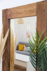 a couch in a living room with a potted plant at Benimar La Cala in Cala de Finestrat