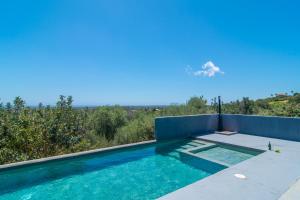 a swimming pool on the roof of a house at Finca Agroturismo Es Pujol in Santanyi