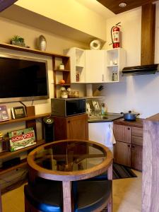 a kitchen with a glass table in a room at Penthouse Condo Studio Unit CENTRIO TOWER w/ Stove in Cagayan de Oro