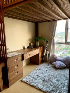 a bedroom with a desk and a loft bed at Penthouse Condo Studio Unit CENTRIO TOWER w/ Stove in Cagayan de Oro +12 photos