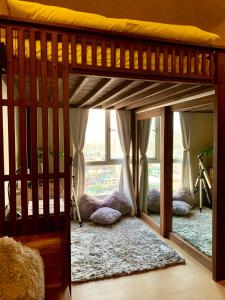 a bedroom with a bunk bed with a large window at Penthouse Condo Studio Unit CENTRIO TOWER w/ Stove in Cagayan de Oro