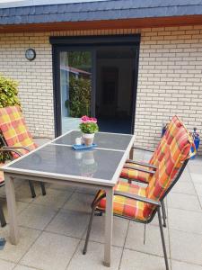 a table and two chairs on a patio at Ferienhaus 7a in Munster im Heidekreis