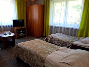 Łóżko lub łóżka w pokoju w obiekcie Willa "Zimowit" w Wiśle