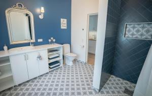 a bathroom with a sink and a toilet and a mirror at Villa & Restoran Soffa in Haapsalu