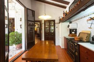 a kitchen with a wooden table in a room at Villa Charly Casa señorial XVII Historical Villa in Macastre