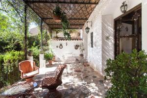 an outdoor patio with chairs and a table at Villa Charly Casa señorial XVII Historical Villa in Macastre