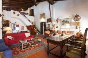 a living room with a red couch and a table at Villa Charly Casa señorial XVII Historical Villa in Macastre