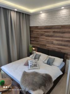 una camera da letto con un letto con un tocco di legno di Armeria Residence Snow a Štrbské Pleso
