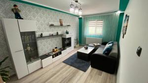 a living room with a couch and a table at Ca acasa Corbu 2 in Corbu