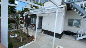 anterior view of a house with a pergola at Ca acasa Corbu 2 in Corbu