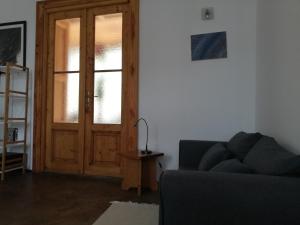 sala de estar con sofá y puerta de madera en Karádi-Berger Vendégház en Erdőbénye