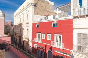 a red building on the side of a building at Corallo Residence in Procida