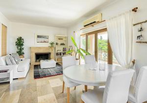 a living room with a white table and chairs at Sanidiamonds in Sani Beach