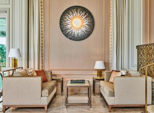 a living room with two chairs and a table at La Réserve de Beaulieu in Beaulieu-sur-Mer